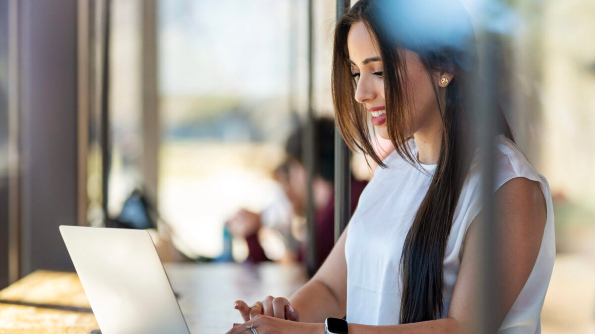 A student exploring ideas on her laptop at Mays Business School